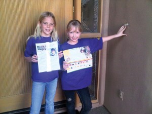 Morgan Foster (L) and Haidyn Moroz (R) selling Girl Scout cookie