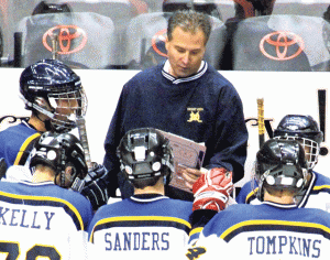 DV hockey coaching team hanging up skates 