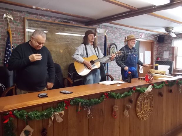 Three members of Flock of Free Range Children John Davis, from left, Ron Van Nostrand and Don Watkins perform at the birthday party for former President Millard Fillmore Sunday in the Summerhill Town Hall. (Photo by Jessica Soule)