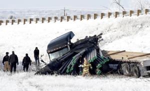 Semi jackknifes and slides down I-90 embankment near Billings