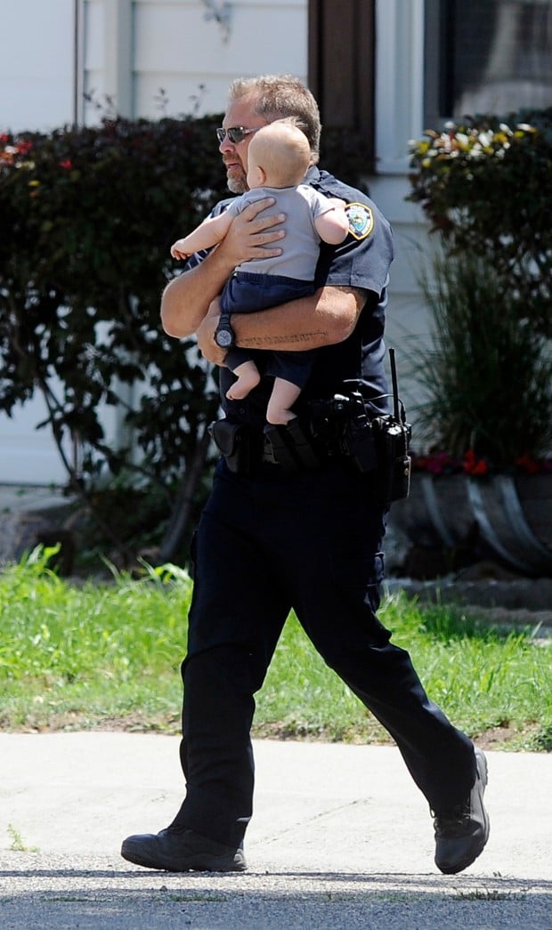 A Laurel police officer carries a child to safety