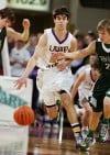 Laurel's Brett Thompson pushes the ball up the floor