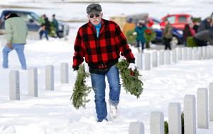 Wreaths placed on graves to honor veterans at Yellowstone National Cemetery