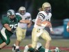 Dillon quarterback Ben Folsom rushes past Justin Harpster