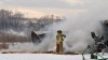 A Laurel firefighter works on controlling a barn fire