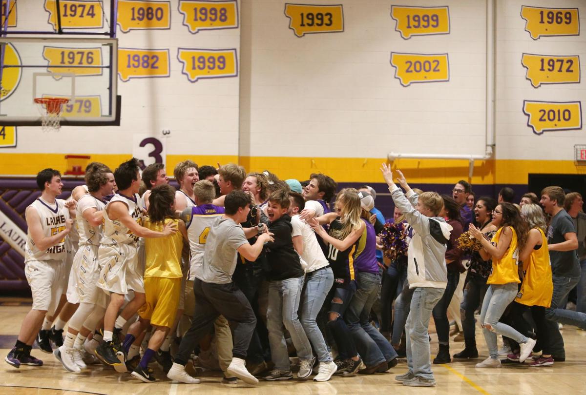 Teammates surround Laurel's Christian Jones