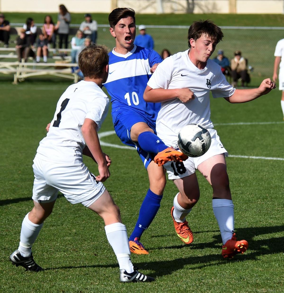 Corvallis' Rutger Klein passes through Central's Logan Tracy