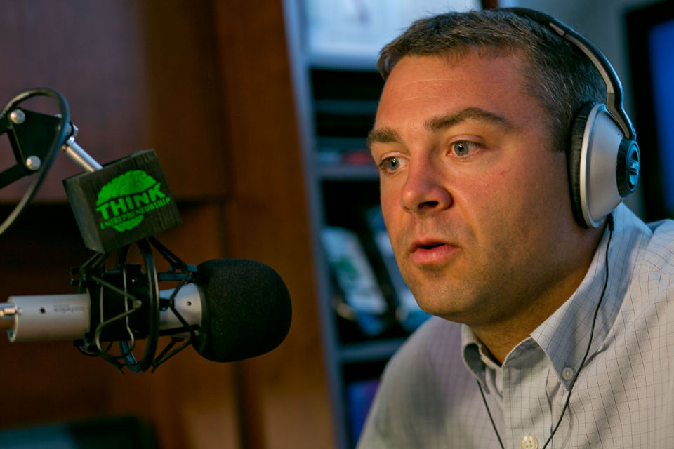 Pete Sveen with a podcast microphone
