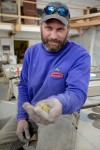 <p>Jon Cross, owner of Ecomatrix Solutions, holds a handful of crushed glass at his facility in Bozeman, on Wednesday. EcoMatrix Solutions is a large buyer of recycled glass which in turn use for building concrete structures, as in countertop surfaces and other products.</p>
