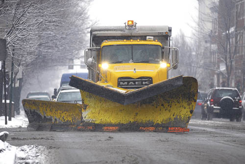 A PennDot snow plow drives up A PennDot snow plow drives up