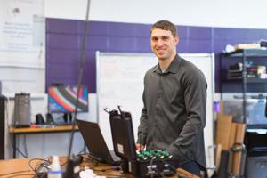 Ben Shuman, a PhD student in the Steele Lab, smiles while working with electromyography equipment (EMG). Photo credit: Liam Brozik