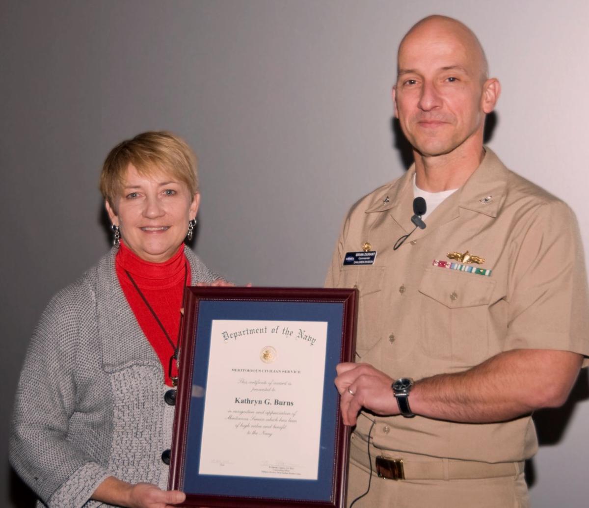 Capt. Durant presents Navy Meritorious award to Kathryn Burns