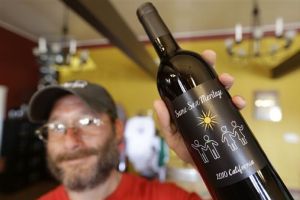 <p>In this photo taken Friday, June 7, 2013, winemaker Josh Stein of Stein Family Wines poses with his Same Sex Meritage red wine at his tasting room on Treasure Island in San Francisco. Gay marriage has been a hot topic for some months now, so perhaps it's not surprising the wine world has taken note with two new wines that declare their support for same-sex couples right on the label. (AP Photo/Eric Risberg)</p>
