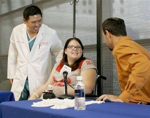 Mother holds conjoined twins for the first time 