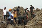Rescuers search for landslide survivors 