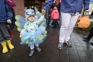 Downtown trick-or-treaters unfazed by downpour