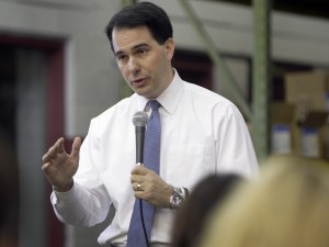 Walker denies knowing of wrongdoing by former top aides