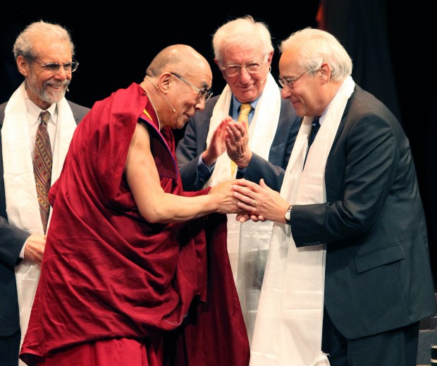 Dalai Lama thanks panel participants with scarves