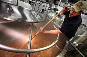 Tanner Brethorst, president and brewmaster of Port Huron Brewing Co. in Wisconsin Dells, stirs his first batch of what will become Honey Blonde Ale. Brethorst, who began production on Wednesday, plans to make about 900 barrels this year and distribute his beer in the Wisconsin Dells area.
