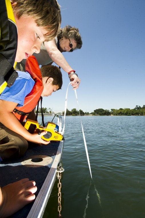 Kids from Outdoor Adventure Club help measure clarity at Lodi Lake