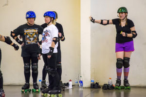 Reporter Skates After Her Derby Girl Dreams : News-Sentinel reporter Sara Jane Pohlman steadies herself with the wall as other roller derby “noobies” practice stopping.
 - Photo by Dan Evans/News-Sentinel