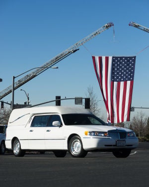 Fallen Galt Police Officer Kevin Tonn Laid To Rest : An American flag waves in the wind as the funeral procession arrives at Adventure Community Church in Roseville where the funeral for Galt Police Officer Kevin Tonn was held on Monday, Jan. 21, 2013.
 - Photo by Dan Evans/News-Sentinel