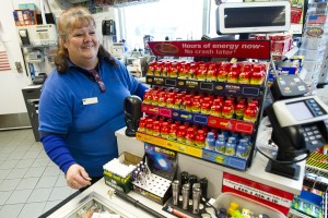 Holiday Grind: Locals Share Motives For Working On Christmas: Cathy Huber helps a customer while working at Chevron on Christmas Day.
 - Photo by Dan Evans/News-Sentinel