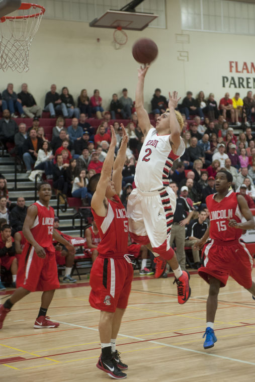 Boys basketball: Flames return to championship form with victory over Trojans 