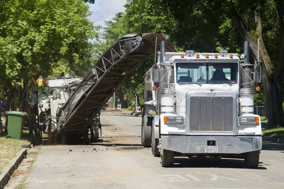 Asphalt grinder tears up road for water main project