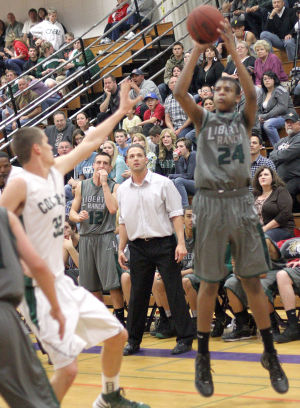 Boys Basketball: Hawks Outlast Falcons In Overtime, Advance To Section Championship : Liberty Ranch Hawks varsity boys basketball coach Josh Williams, center, watches as DeAndre Stallings shoots and scores on one of his six three-point baskets against the Colfax Falcons at Tokay High School on Wednesday, Feb. 27, 2013. The Hawks beat the Falcons 64-59 in overtime to advance to the Sac-Joaquin Section Division IV championship against the Summerville Bears of Tuolumne at Sleep Train Arena in Sacramento on Saturday, March 2, 2013.
 - Photo by Jerry R. Tyson/News-Sentinel