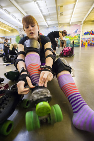 Reporter Skates After Her Derby Girl Dreams : News-Sentinel reporter Sara Jane Pohlman secures her skates before practicing with the Port City Roller Girls roller derby team at the San Joaquin County Fairgrounds on Thursday, Feb. 7, 2013.
 - Photo by Dan Evans/News-Sentinel
