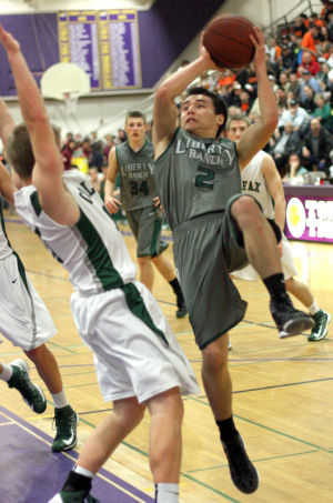 Boys Basketball: Hawks Outlast Falcons In Overtime, Advance To Section Championship : Matt Thomas of the Liberty Ranch Hawks drives to the basket against a Colfax Falcons defender at Tokay High School on Wednesday, Feb. 27, 2013. The Hawks beat the Falcons 64-59 in overtime to advance to the Sac-Joaquin Section Division IV championship against the Summerville Bears of Tuolumne at Sleep Train Arena in Sacramento on Saturday, March 2, 2013.
 - Photo by Jerry R. Tyson/News-Sentinel