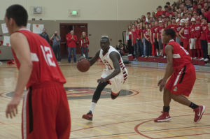 Boys basketball: Flames return to championship form with victory over Trojans 