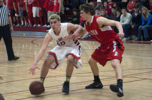 Boys basketball: Flames return to championship form with victory over Trojans 