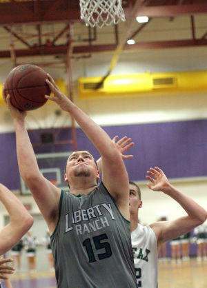 Boys Basketball: Hawks Outlast Falcons In Overtime, Advance To Section Championship : Nick Friend goes up and scores against a Colfax Falcons defender at Tokay High School on Wednesday, Feb. 27, 2013. The Hawks beat the Falcons 64-59 in overtime to advance to the Sac-Joaquin Section Division IV championship against the Summerville Bears of Tuolumne at Sleep Train Arena in Sacramento on Saturday, March 2, 2013.
 - Photo by Jerry R. Tyson/News-Sentinel