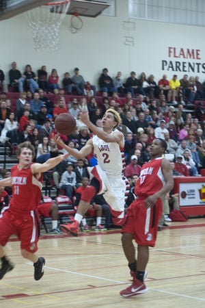 Boys basketball: Flames return to championship form with victory over Trojans 