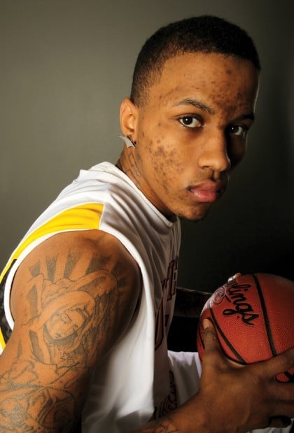 men's basketball player Fabyon Harris shows his tattoo in remembrance of