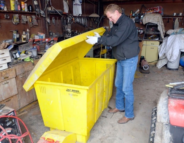 Jack Stivers opens a calf warming box