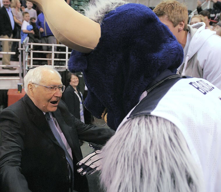 Elder Perry hugs Utah State mascot.