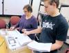 <p>Kerri Williams and Jaron Lott count election ballots at the Cache County Administration building on Monday. (Eli Lucero/Herald Journal)</p>