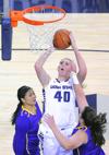 <p>Utah State center Hannah Hutchins takes a shot as Western New Mexico's Ashley Mitchell, left, and Stephanie Moore defend, Monday in Logan. (Eli Lucero/Herald Journal)</p>