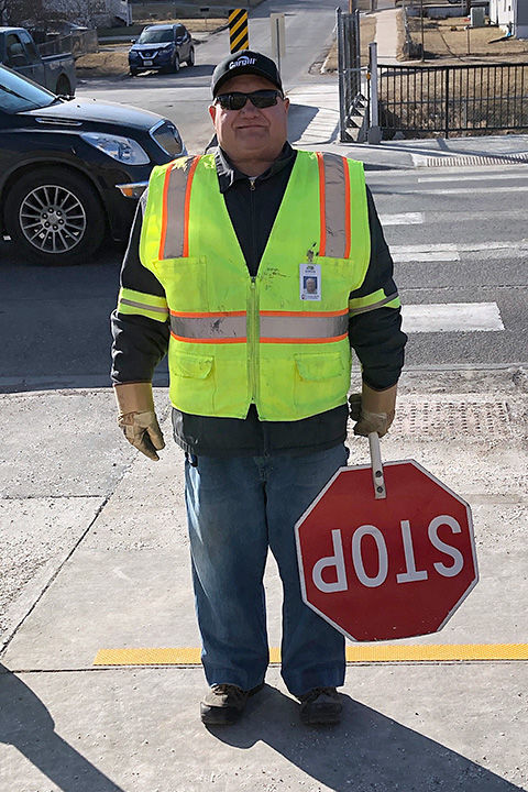 school crossing guard saves two students from oncoming car