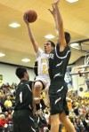 Kouts' Matt Badley shoots between the defense