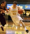 Valparaiso University's Matt Kenney drives against Loyola's Joe Cfisman, a Munster grad,