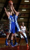 West Side player Lexus Fox comes up with a rebound against Lake Central's Chrissy Addison and Jessica Bell 