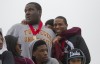 Antonio Pipkin throws his arms around Jeremy Rucker, left, and Carlos McCormick