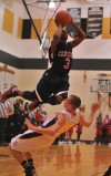 Kouts' Cody Nelson tries to draw a charging foul on 21st Century's Mykel Mayes on Wednesday.