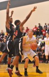 Kouts' Cody Nelson looks for an opening against Gary 21st Century's defense Wednesday.