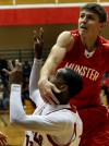 E.C. Central's Hyron Edwards takes a slap in the face from Munster's Mike Schlotman
