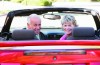 Couple in convertible car smiling